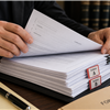 Process server reviewing legal documents for missing exhibits